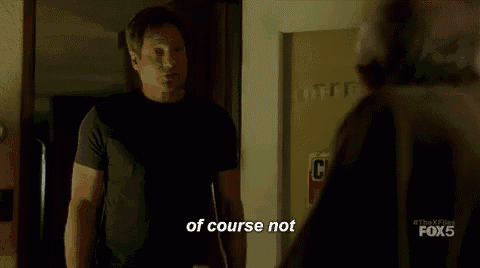 a man in a black shirt is standing next to another man in a room and says `` of course not '' .