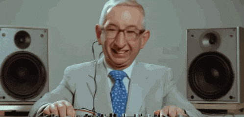 an older man in a suit and tie is playing music