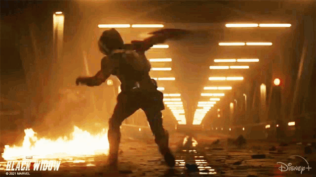 a poster for the movie black widow shows a woman fighting a fire