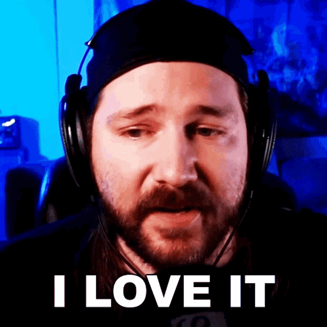 a man with a beard wearing headphones says " i love it "