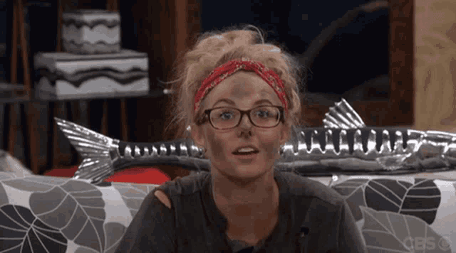 a woman with glasses and a bandana on her head