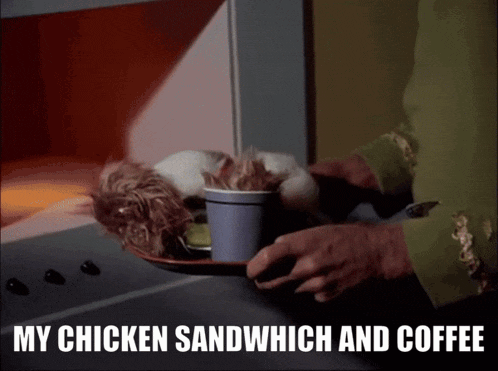 a chicken sandwich and a cup of coffee are on a tray