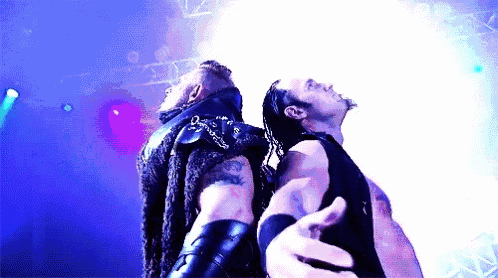 two men are standing next to each other with their hands outstretched