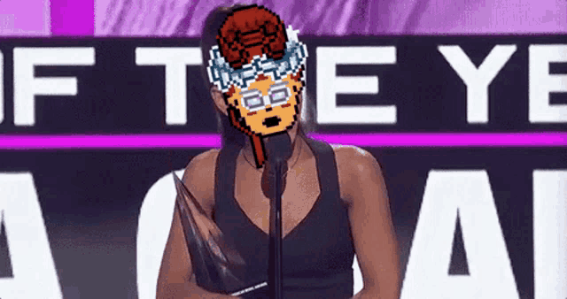 a woman is holding a trophy in front of a sign that says " if the eye "