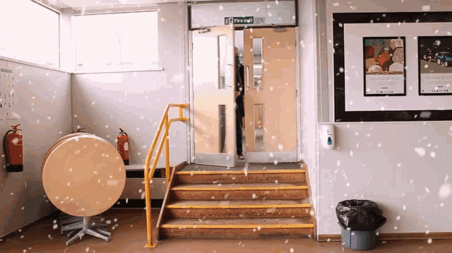 a room with a fire exit sign above the door