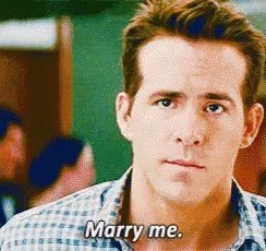 a man in a plaid shirt is saying marry me .