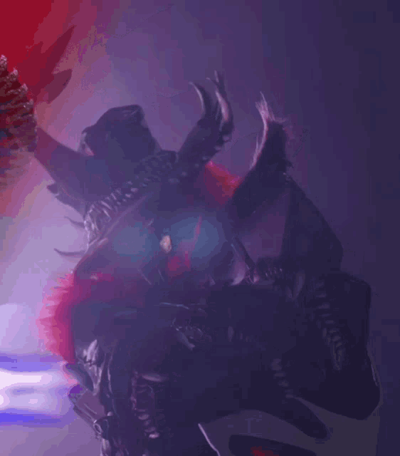 a close up of a monster with a purple background and the letter t