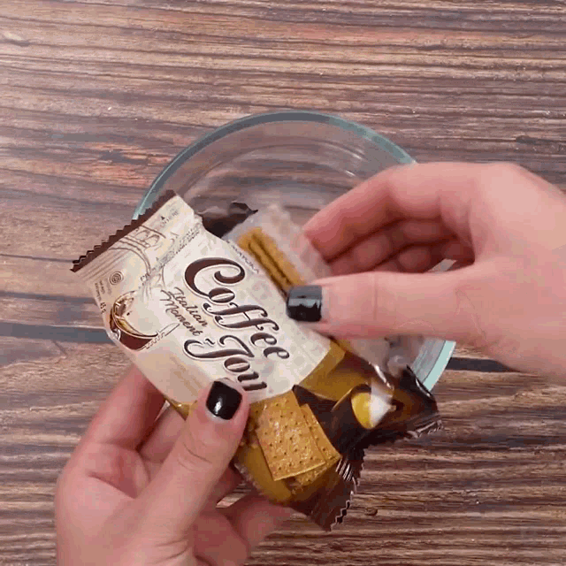 a person is holding a bag of coffee jam cookies
