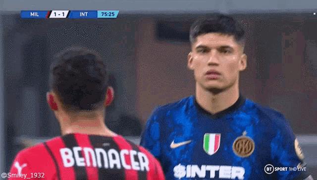 two soccer players are standing next to each other and one of them has the name bennacer on his jersey