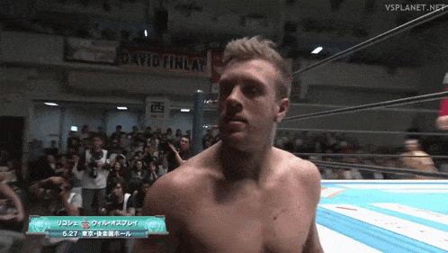 a man in a wrestling ring with a sign that says david finlay
