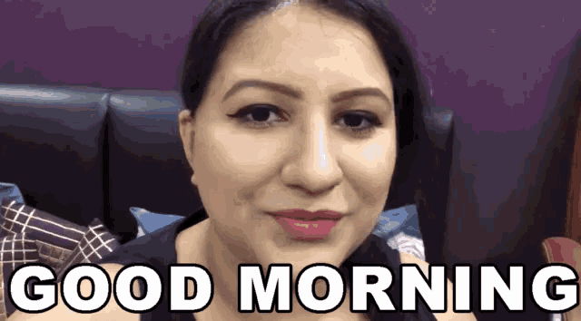 a woman says good morning in front of a purple background