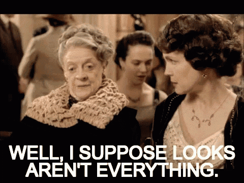 two women are standing next to each other and one of them says well i suppose looks aren 't everything ..