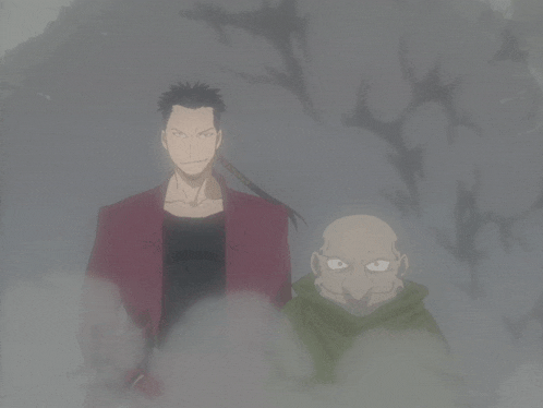 a man in a red jacket is standing next to a bald man in a green hoodie