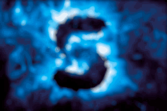 a blurred image of the number 3 on a dark background