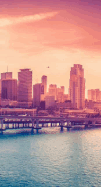 a blurry picture of a city skyline with a bridge in the foreground