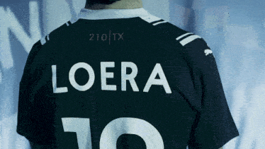 a man is wearing a black shirt with the name loera on the back