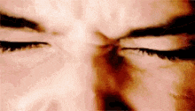 a close up of a person 's eyes with their eyes closed and their eyebrows visible .