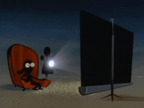 a cartoon character sitting in a chair watching a movie