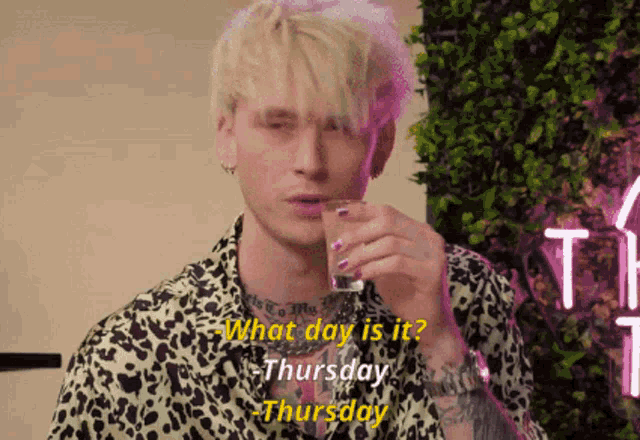 a man in a leopard print shirt is drinking from a shot glass and says what day is it thursday thursday