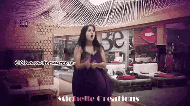 a woman in a purple dress is standing in a room with michelle creations on the bottom