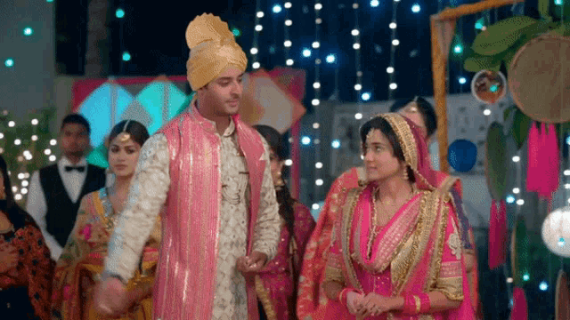 a bride and groom standing next to each other at a wedding reception