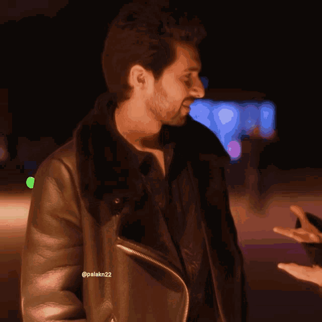 a man wearing a black leather jacket with the hashtag palakin22 on the bottom right
