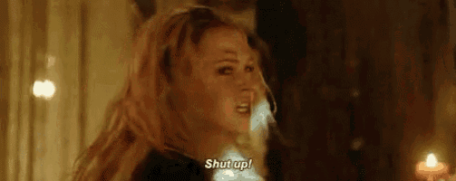 a woman is screaming and saying `` shut up '' in a dark room .