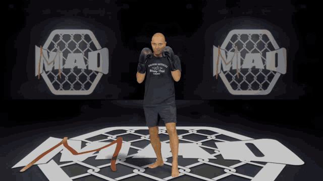 a man wearing boxing gloves is standing in front of a mma logo