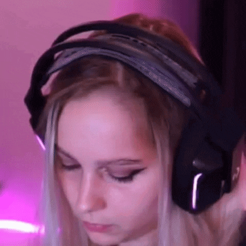 a close up of a woman wearing headphones in front of a purple background .