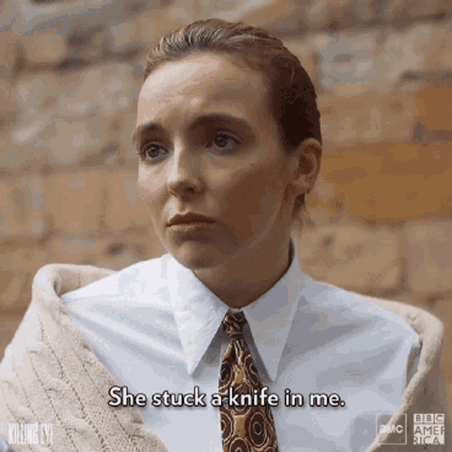 a woman in a white shirt and tie is saying she stuck a knife in me .
