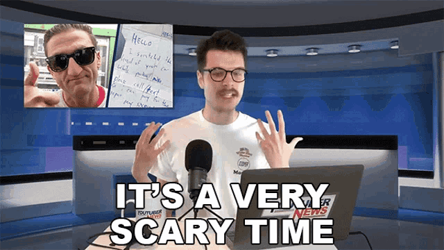 a man sitting in front of a laptop with the words it 's a very scary time below him