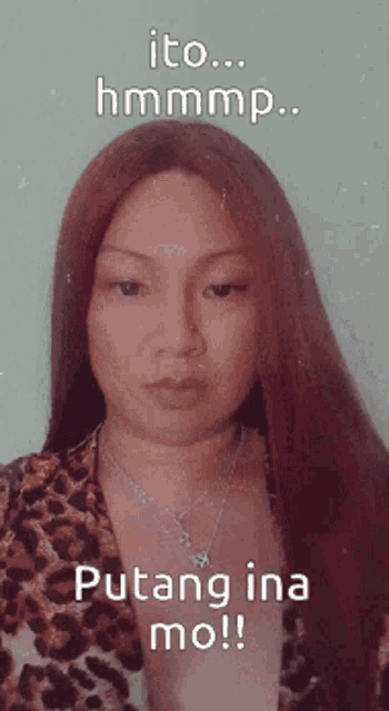 a woman with long red hair is wearing a leopard print jacket and a necklace
