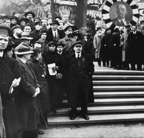 a black and white photo of a crowd of people standing in front of a sign that says ' communist ' on it
