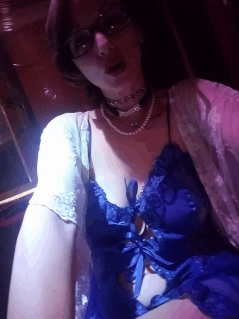 a woman wearing glasses and a choker has the word bunny written on her neck