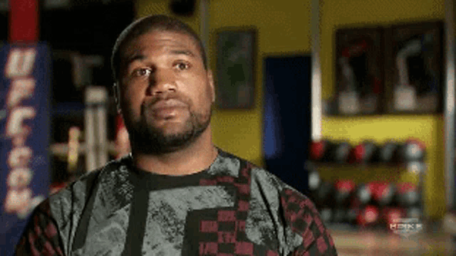 a man with a beard wearing a shirt that says ufc on it