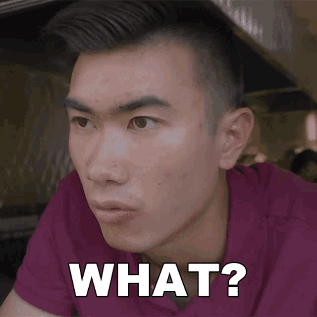 a man with a purple shirt says what