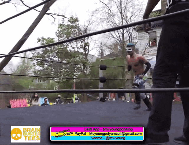 a man in a wrestling ring with a brain buster tee on it