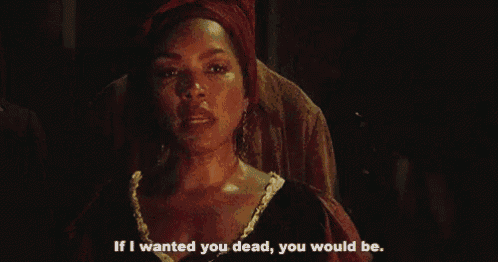 a woman in a red head scarf is talking to a man .