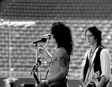 a man with a tattoo on his arm that says ' slash ' on it