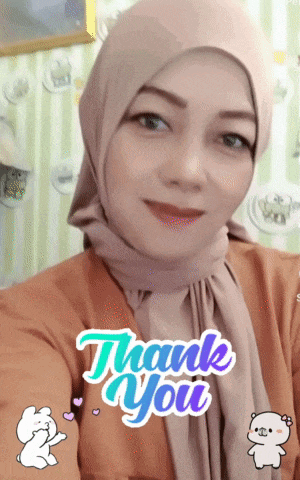 a woman wearing a hijab and a thank you sticker on her face