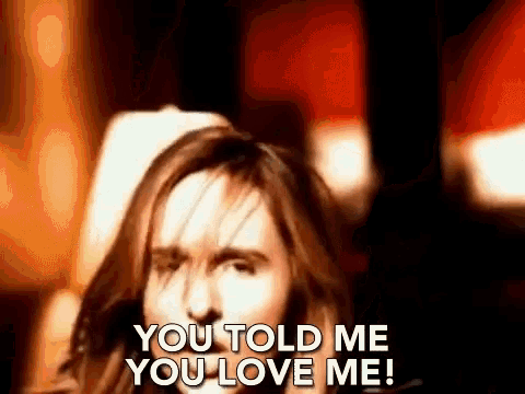 a woman with long hair is saying `` you told me you love me '' in a blurry photo .