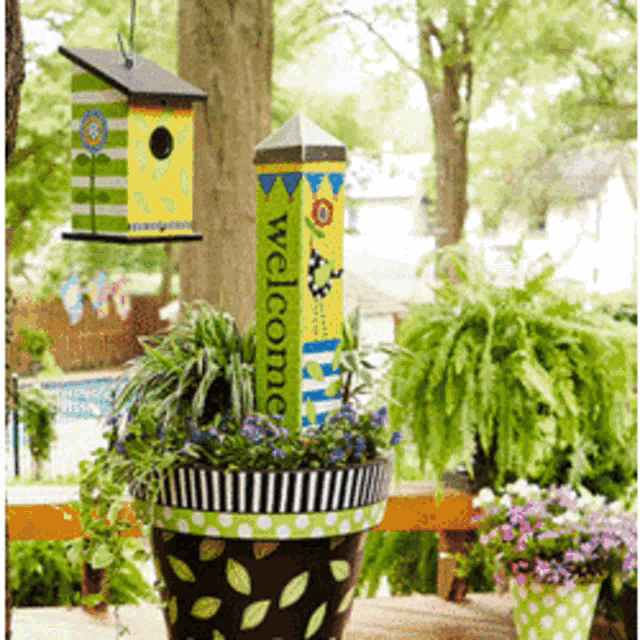 a potted plant with a welcome sign hanging from it