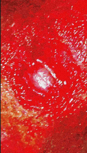 a close up of a red background with a white spot in the middle