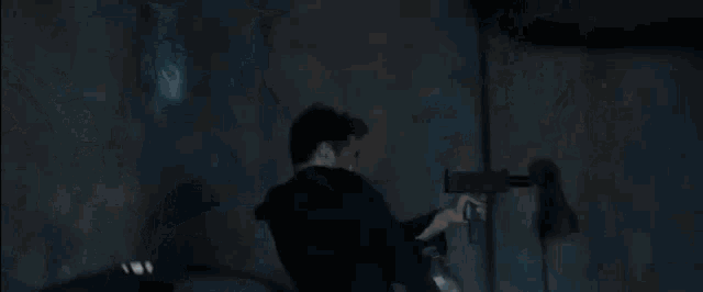 a person is flying through the air in a dark room with smoke coming out of the ceiling .