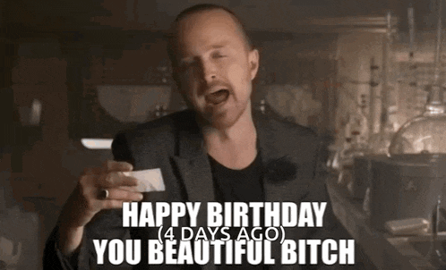a man in a suit is holding a piece of paper in his hand and says happy birthday you beautiful bitch .