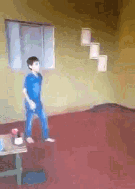 a boy in a blue shirt is standing on a red carpet in a room