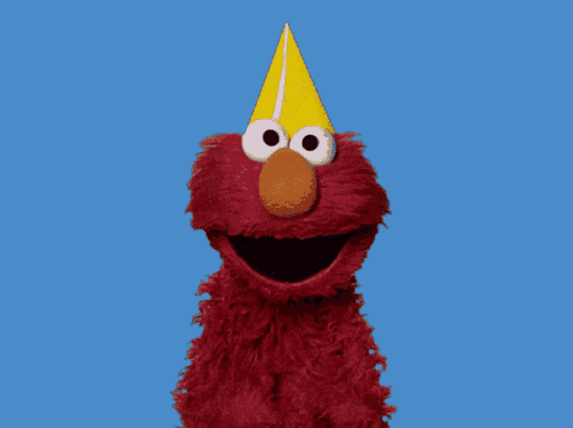 elmo from sesame street with his mouth open against a blue sky