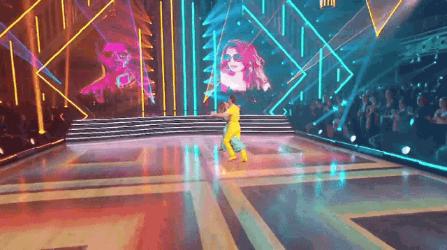 a couple of people are dancing on a dance floor