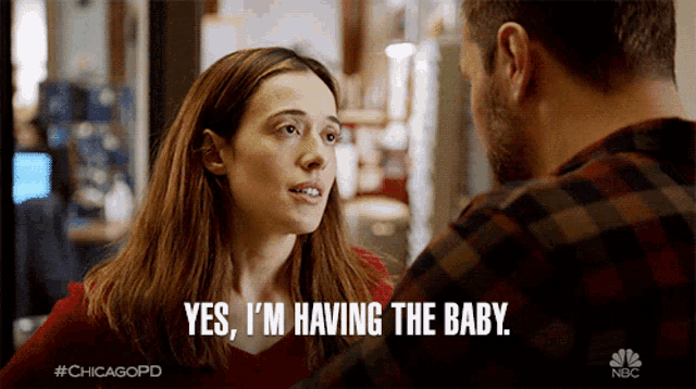 a woman says yes i 'm having the baby in front of a man