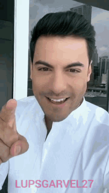 a man in a white shirt is pointing at the camera with the name lupsgarvel 27 written on the bottom